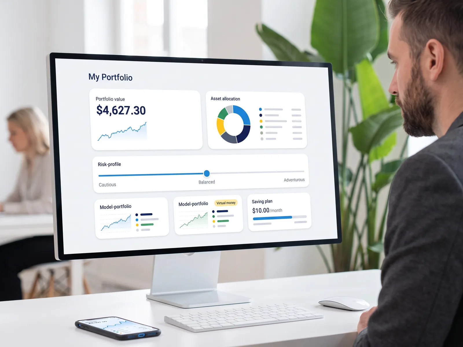 A person looks at a desktop monitor showing a wealth dashboard with portfolio value, asset allocation, a risk-profile slider, model portfolios and a regular saving plan.